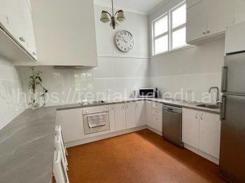Spacious kitchen with breakfast bench, dishwasher and high ceilings